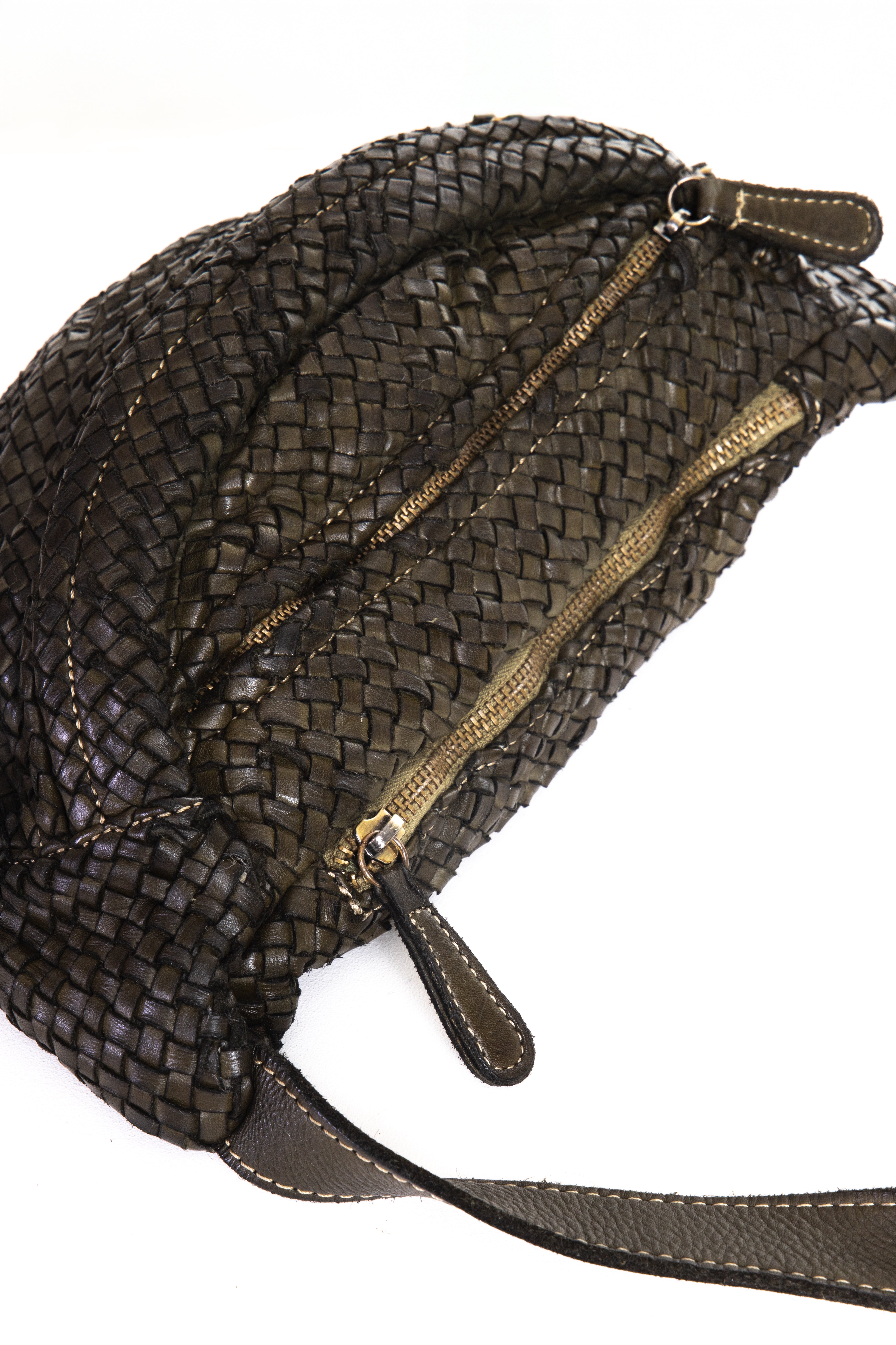 Brown woven handbag with gold zipper on a white background