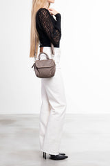 Donna che indossa Florence Satchel Piccola in pelle intrecciata taupe a spalla